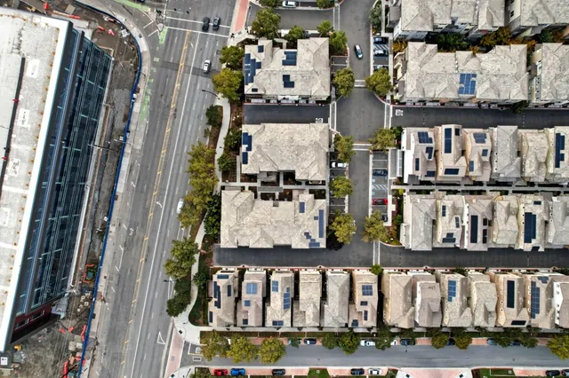 an aerial view of residential houses with outdoor space