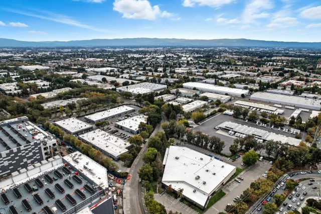 an aerial view of a house with garden space and street view