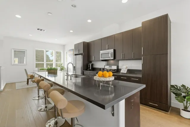 a kitchen with a sink a counter space and appliances