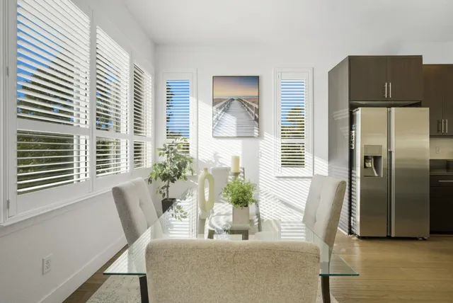 a dining room with furniture and a window