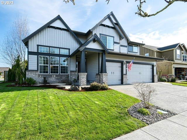 1663 South 14th Circle Ridgefield, WA 98642 - Photo 1 of 29 a front view of a house with a yard and garage