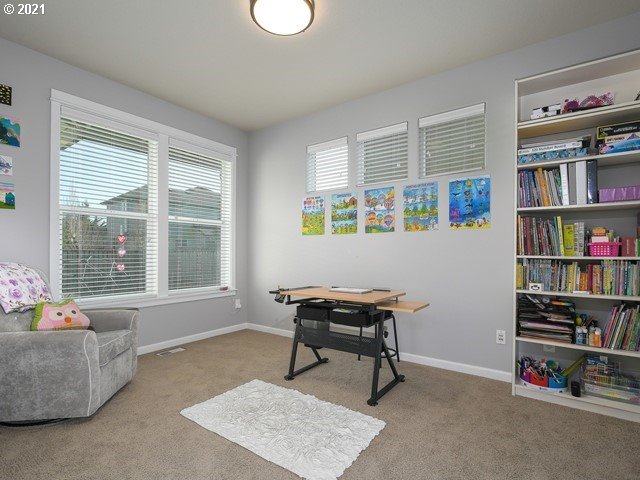 1663 South 14th Circle Ridgefield, WA 98642 - Photo 18 of 29 a living room with furniture and a book shelf