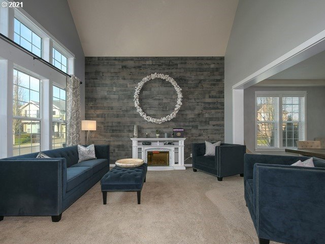 1663 South 14th Circle Ridgefield, WA 98642 - Photo 4 of 29 a living room with furniture a fireplace a flat screen tv and windows