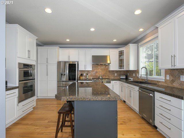 1663 South 14th Circle Ridgefield, WA 98642 - Photo 6 of 29 a large kitchen with granite countertop lots of counter top space stainless steel appliances and cabinets