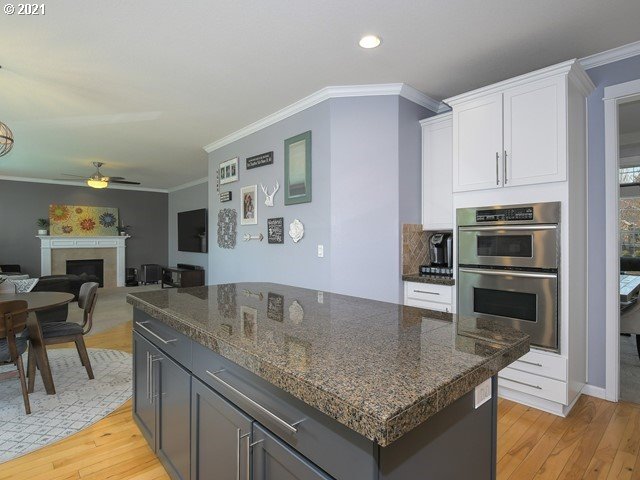 1663 South 14th Circle Ridgefield, WA 98642 - Photo 8 of 29 a kitchen with stainless steel appliances granite countertop a sink a stove and a center island