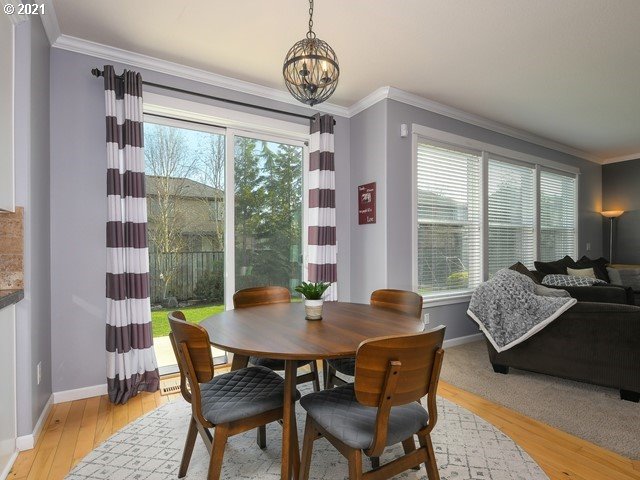 1663 South 14th Circle Ridgefield, WA 98642 - Photo 9 of 29 a dining room with furniture a chandelier and wooden floor