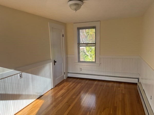 166 High Street, Unit 2 Billerica, MA 01862 - Photo 4 of 5 a view of an empty room with wooden floor and a window