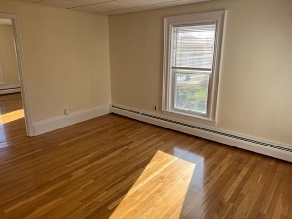 166 High Street, Unit 2 Billerica, MA 01862 - Photo 5 of 5 an empty room with wooden floor and windows