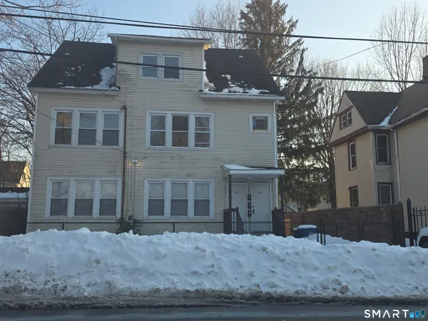 a view of a brick house with a large windows