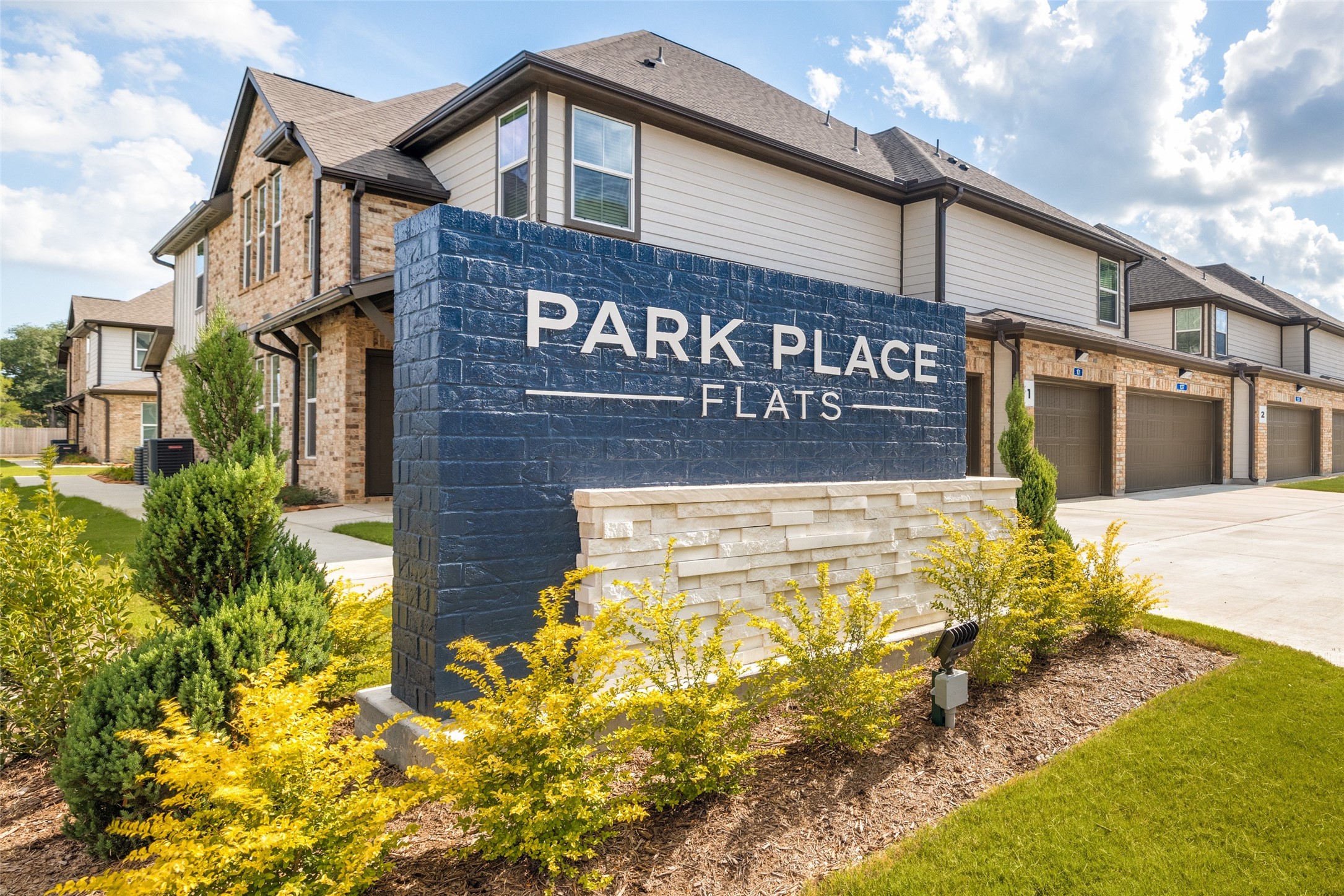 115 Park Place Circle, Unit B Waller, TX 77484 - Photo 1 of 24 a view of a brick building with large windows