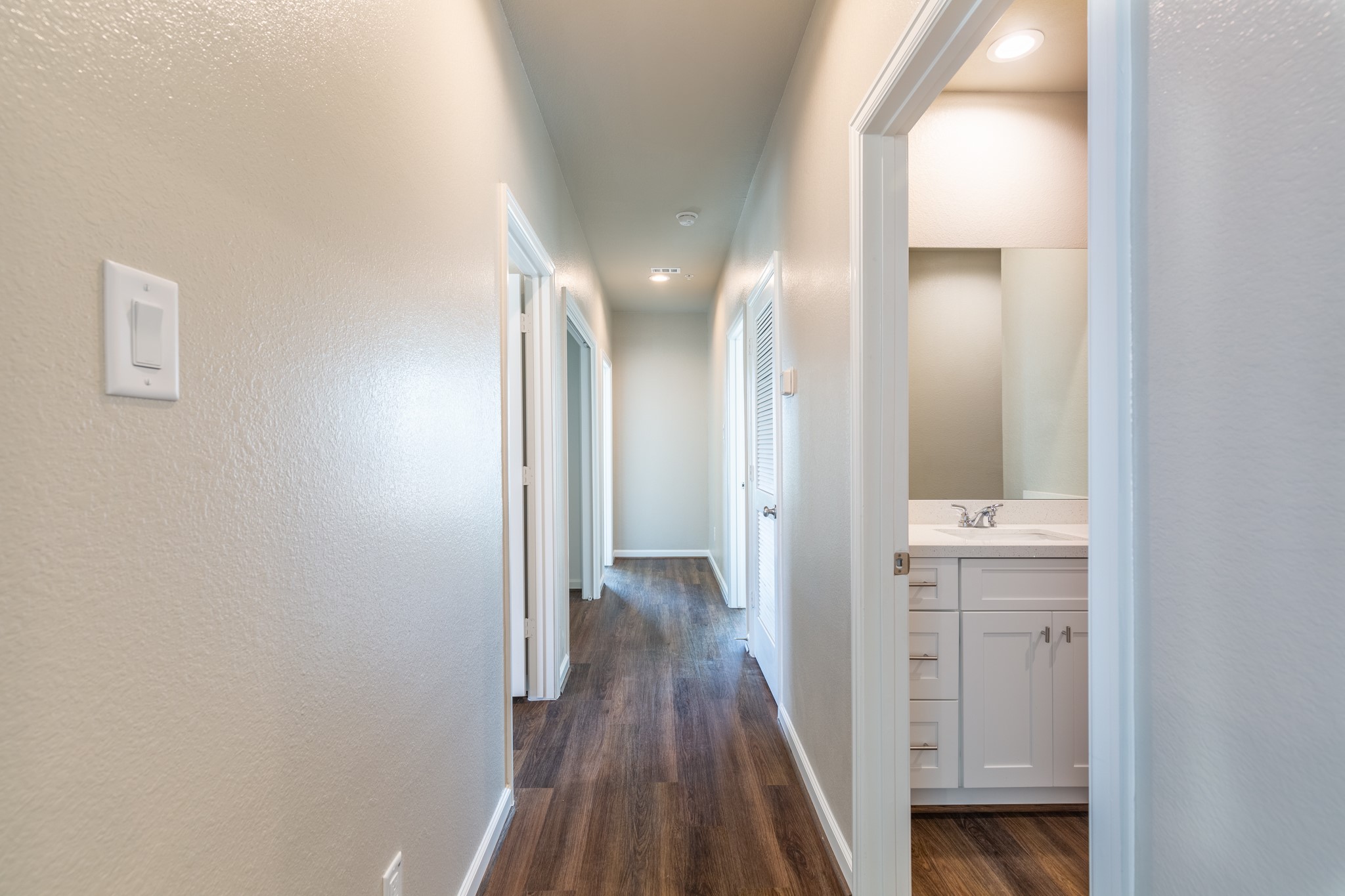 115 Park Place Circle, Unit B Waller, TX 77484 - Photo 12 of 24 a view of a hallway with wooden floor
