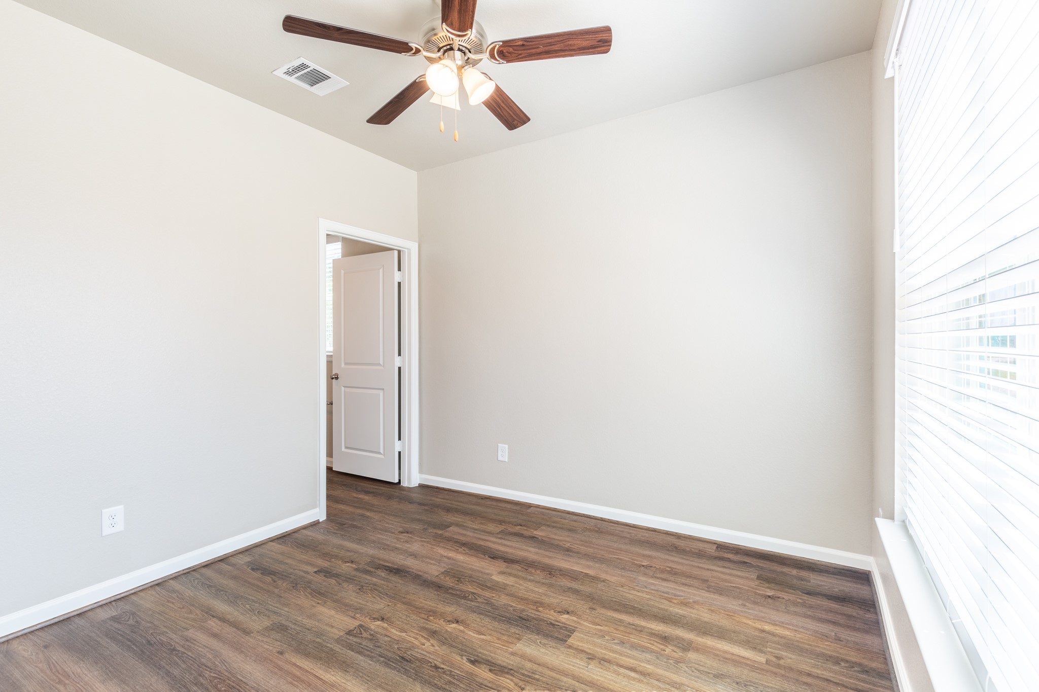115 Park Place Circle, Unit B Waller, TX 77484 - Photo 15 of 24 an empty room with wooden floor closet and fan