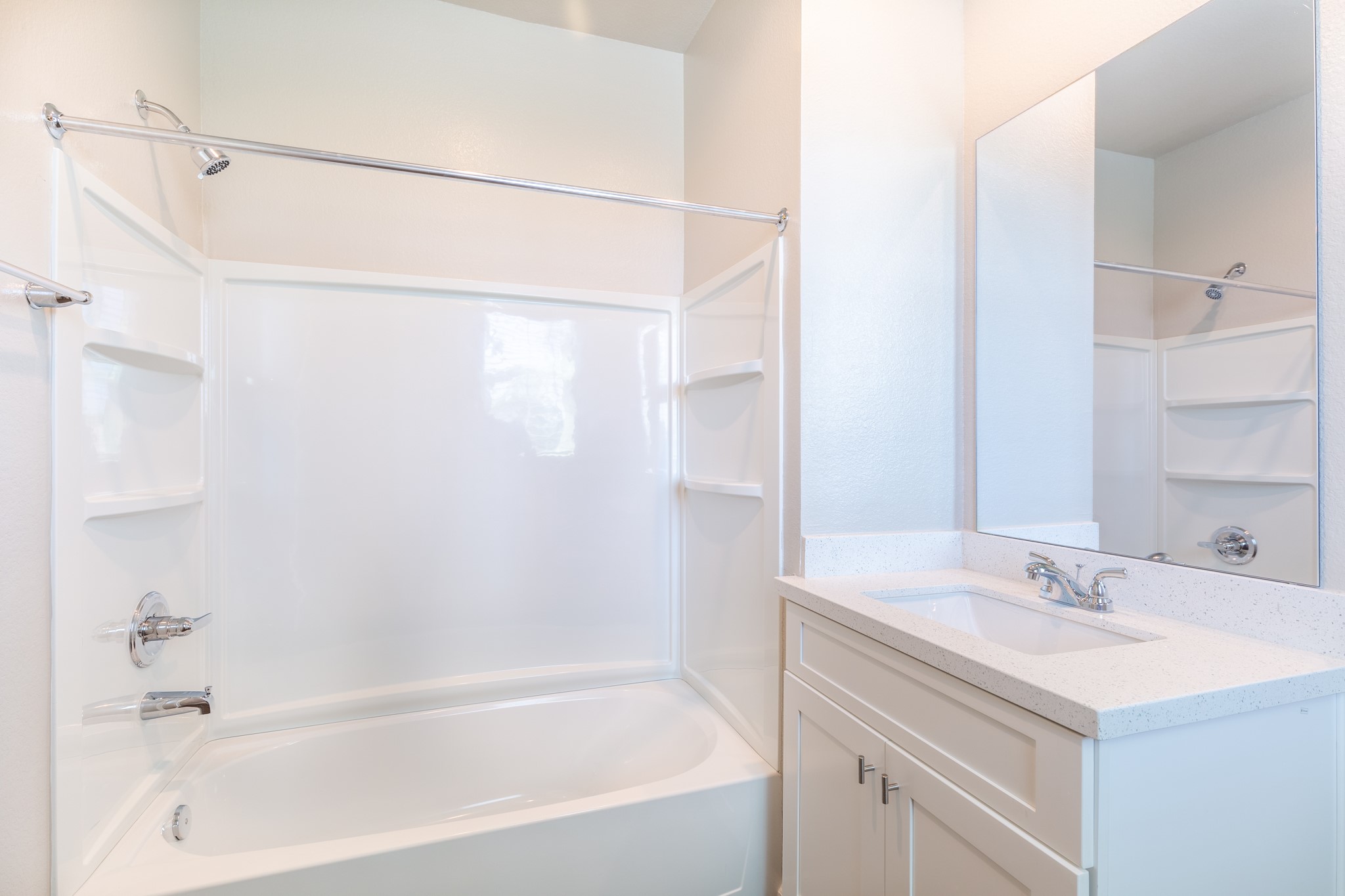 115 Park Place Circle, Unit B Waller, TX 77484 - Photo 17 of 24 a bathroom with a bathtub sink vanity and mirror
