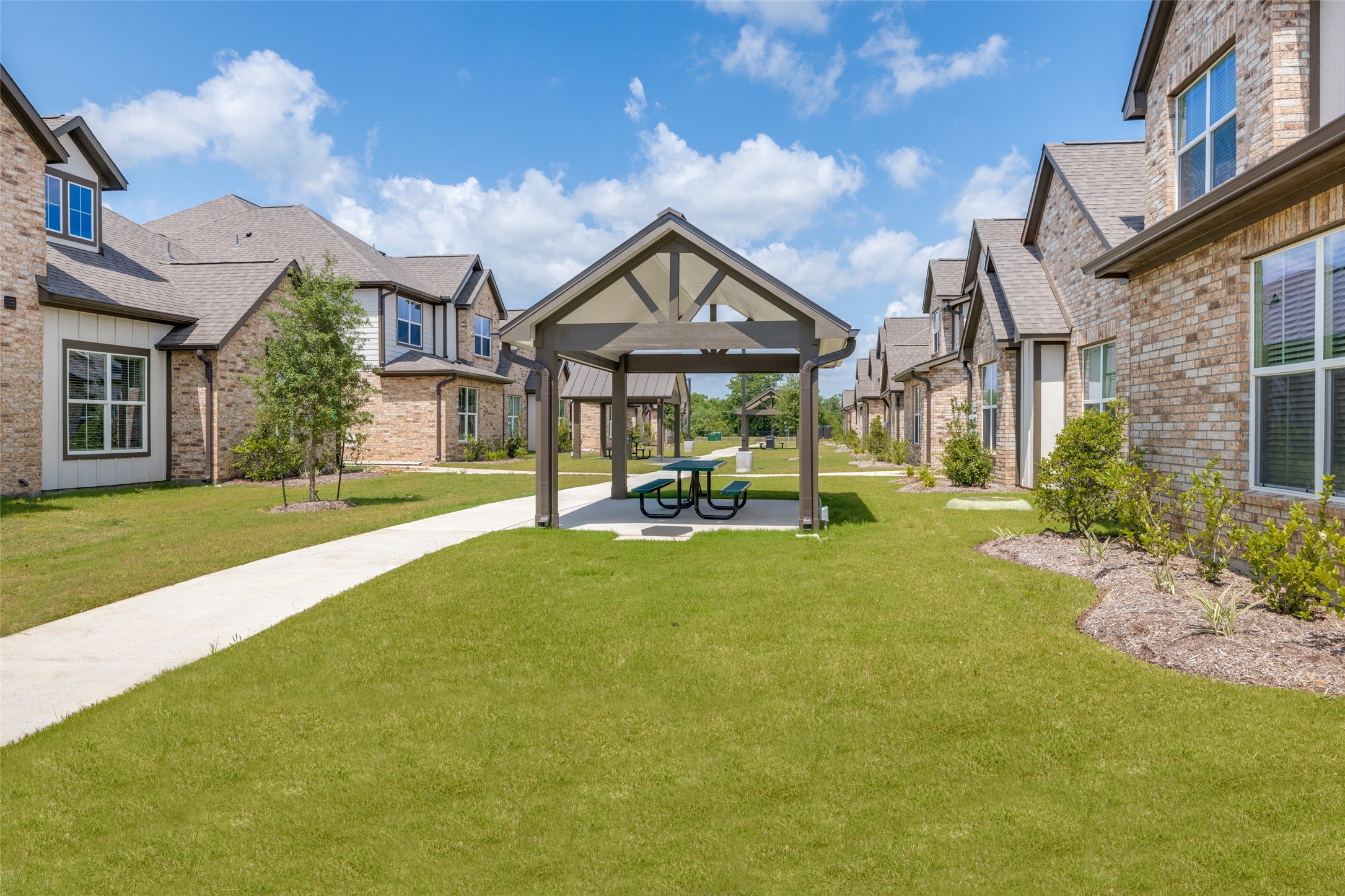 115 Park Place Circle, Unit B Waller, TX 77484 - Photo 2 of 24 a house view with a garden space