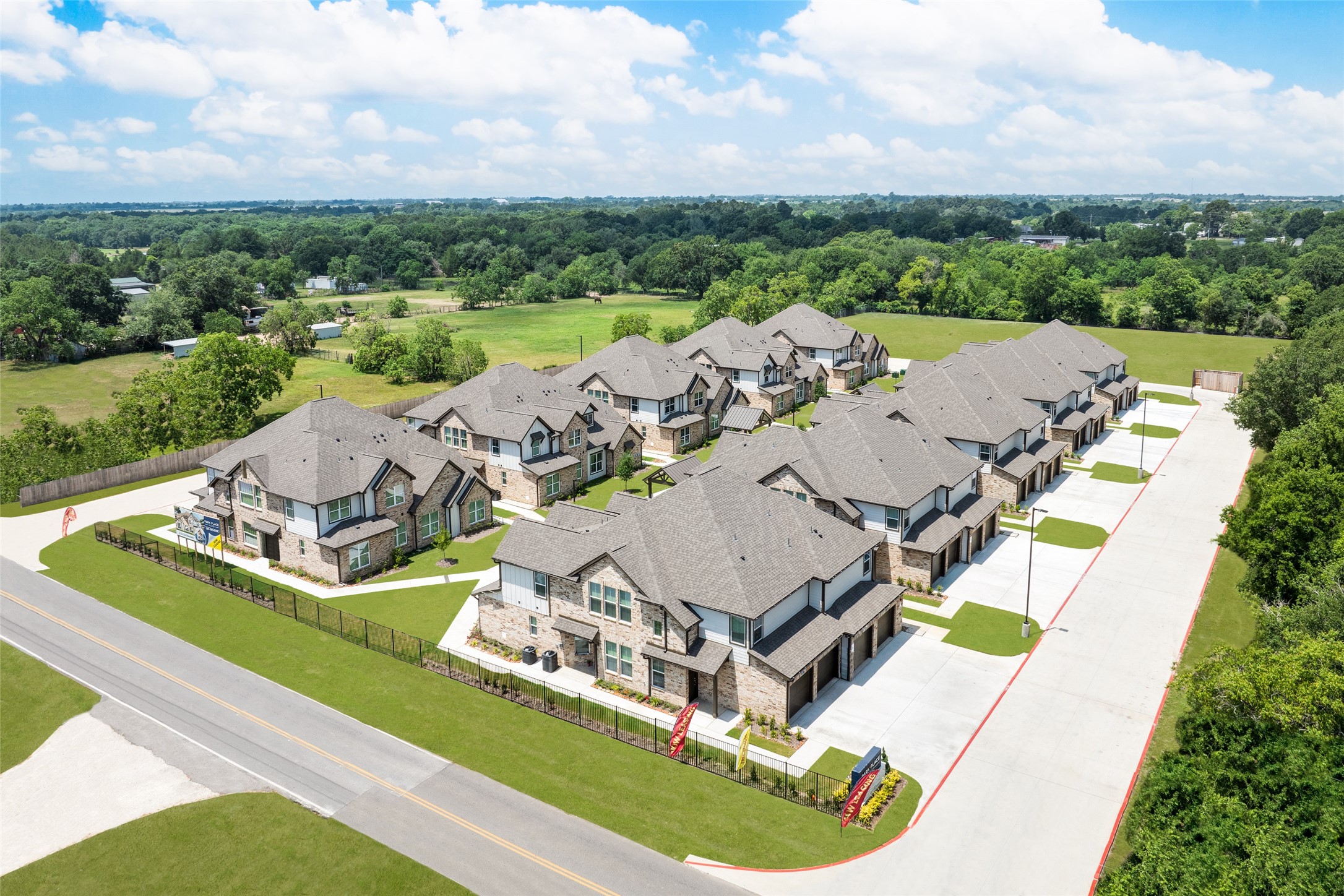 115 Park Place Circle, Unit B Waller, TX 77484 - Photo 23 of 24 an aerial view of a house with a garden and lake view
