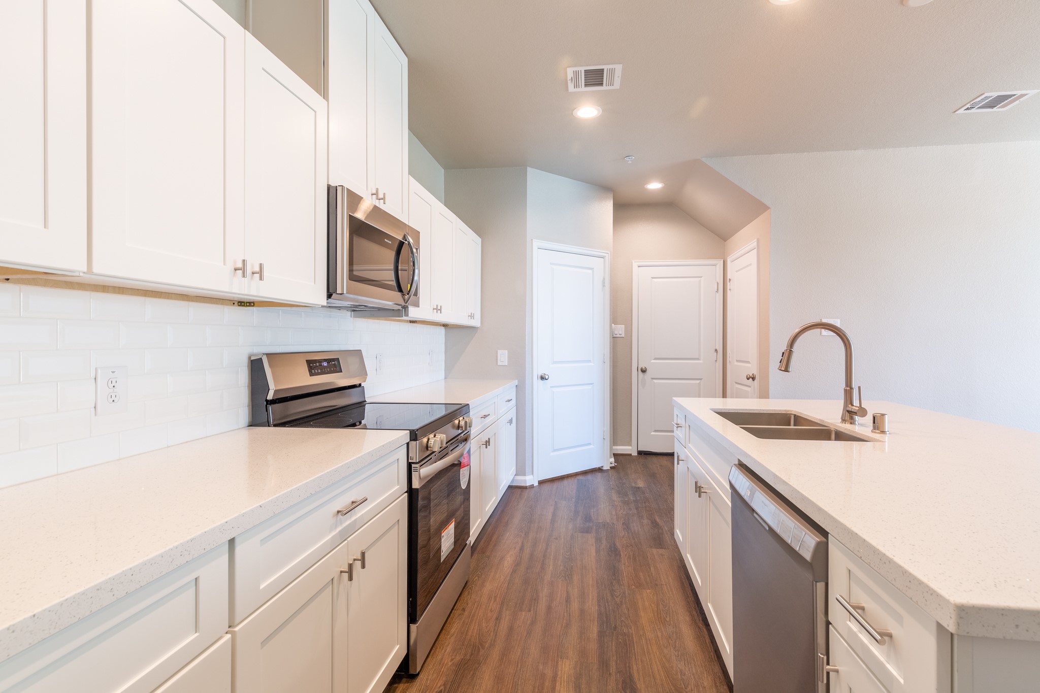 115 Park Place Circle, Unit B Waller, TX 77484 - Photo 10 of 24 a kitchen with stainless steel appliances granite countertop a sink stove and cabinets
