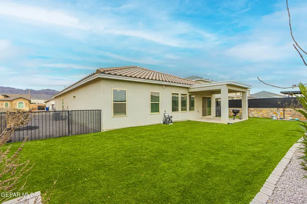 a view of a house with a yard and sitting area