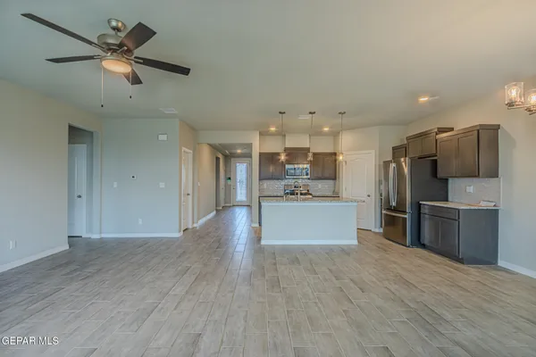 a view of kitchen with refrigerator microwave and stove