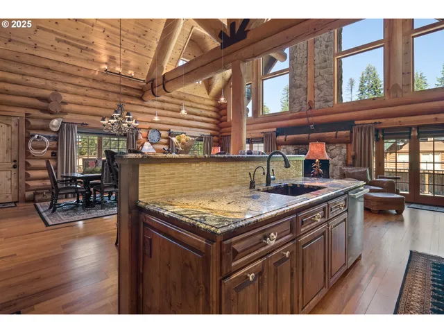 a kitchen with stainless steel appliances granite countertop a stove a sink dishwasher and cabinets with wooden floor