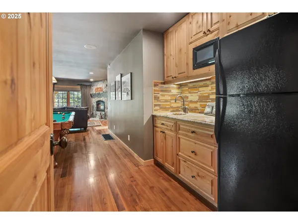 a kitchen with a refrigerator stove and a sink