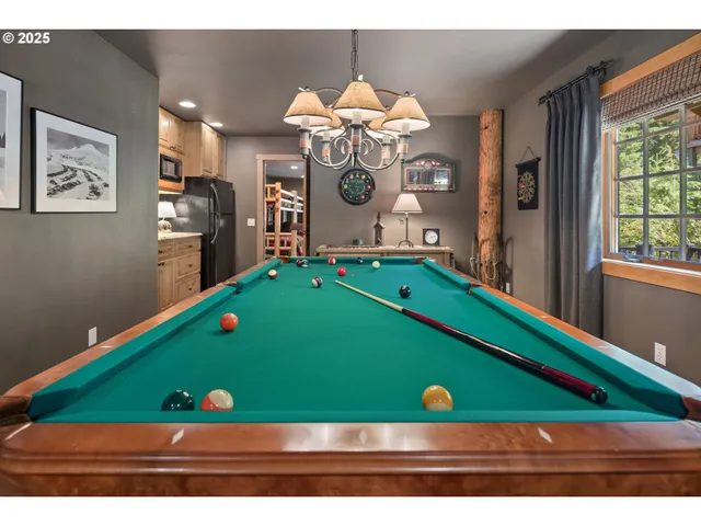 a room with pool table and windows