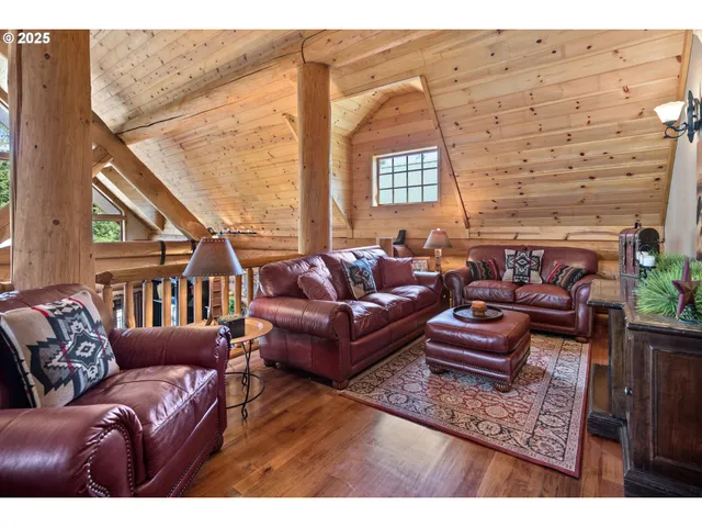 a living room with furniture a rug and a window