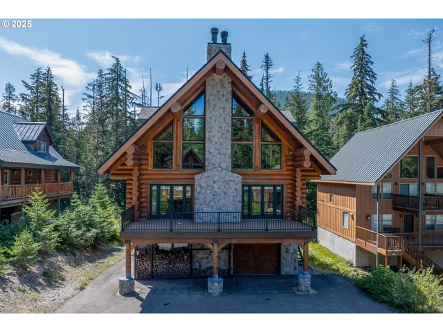 a backyard of a house with wooden deck and furniture