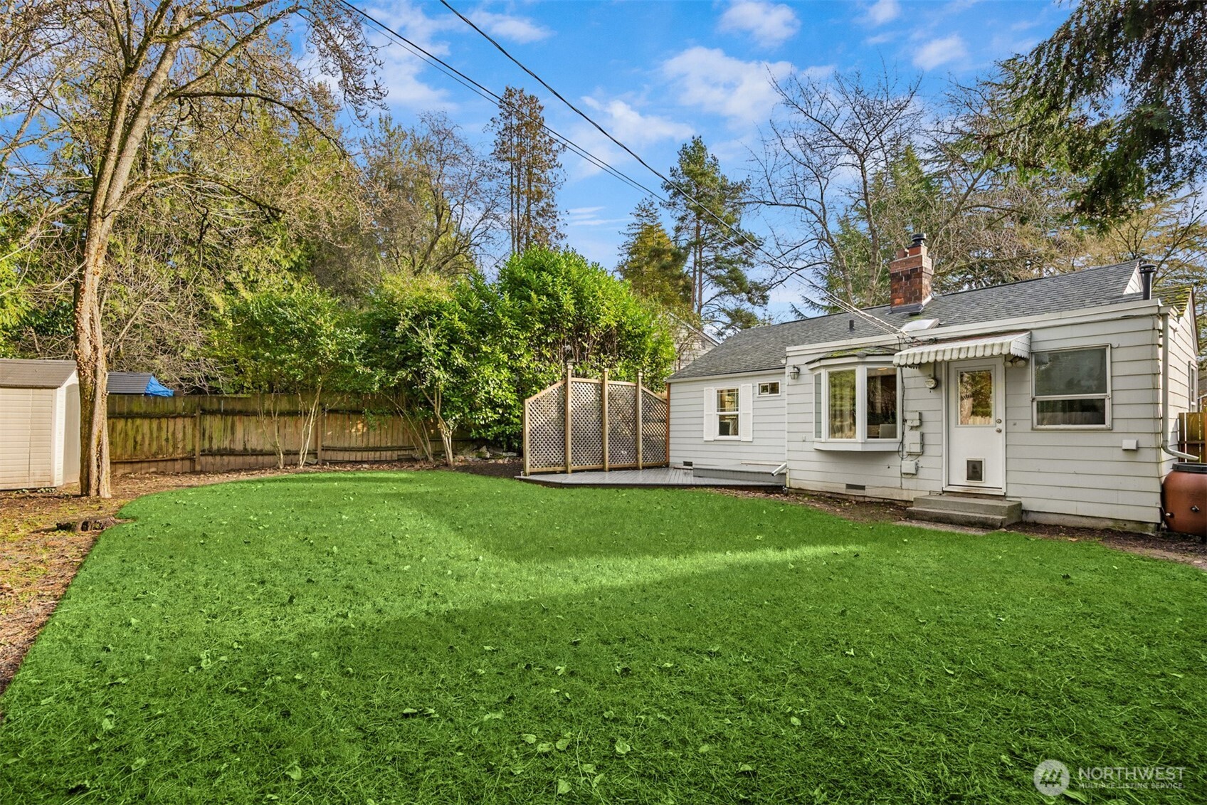 5606 Northeast 59th Street Seattle, WA 98105 - Photo 21 of 28 a front view of a house with a yard and trees