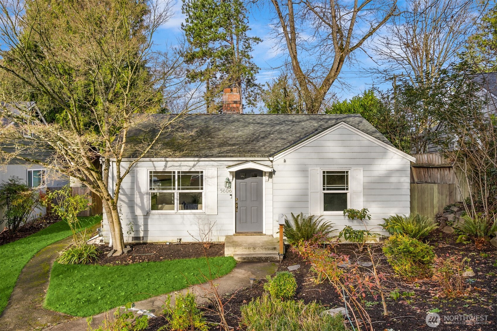 5606 Northeast 59th Street Seattle, WA 98105 - Photo 3 of 28 a front view of a house with a yard and garage