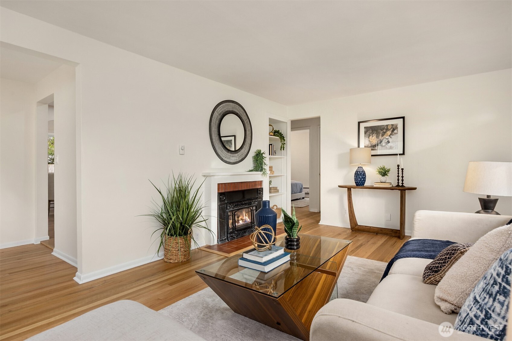 5606 Northeast 59th Street Seattle, WA 98105 - Photo 7 of 28 a living room with furniture a fireplace and a potted plant