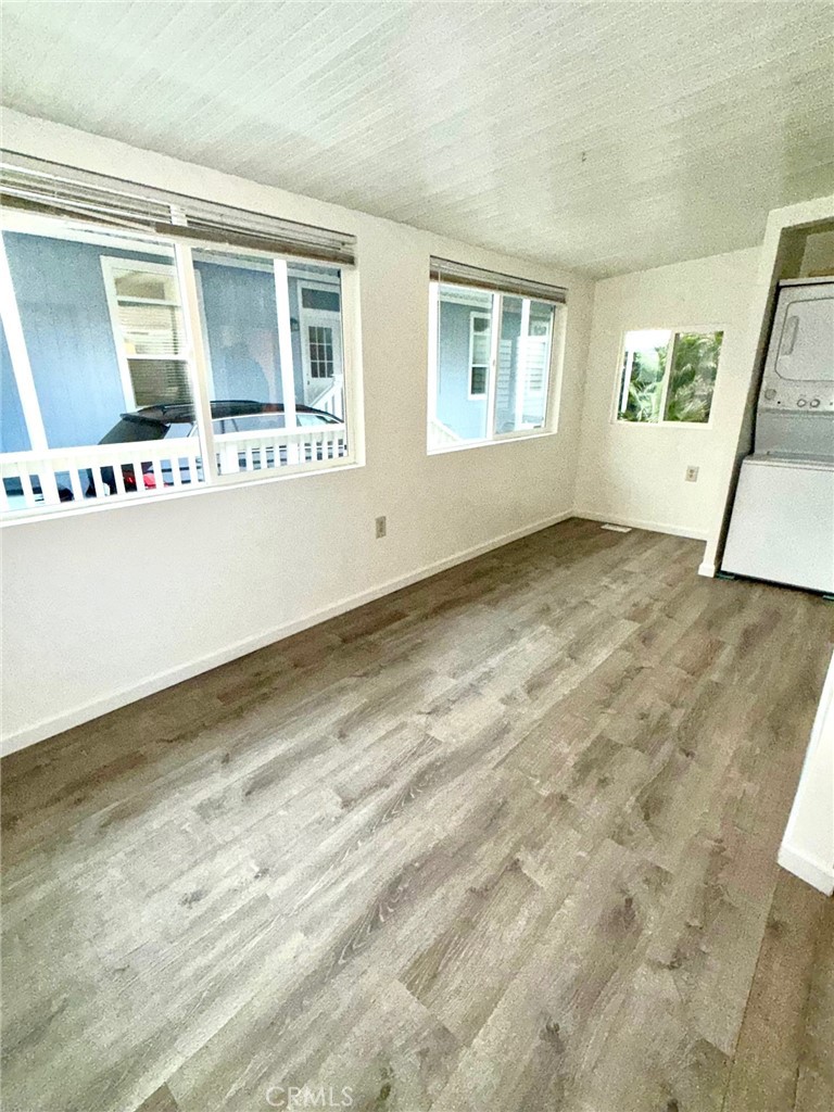 80 Huntington Street, Unit 712 Huntington Beach, CA 92648 - Photo 8 of 12 a view of an empty room with wooden floor and a window