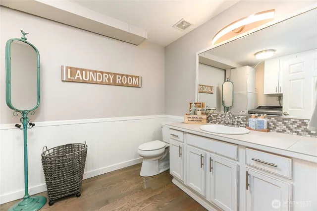 a bathroom with a toilet a sink and mirror