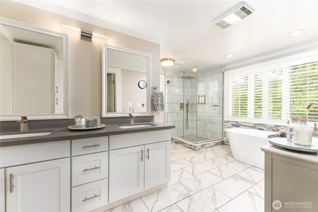 a spacious bathroom with a granite countertop sink mirror and a
