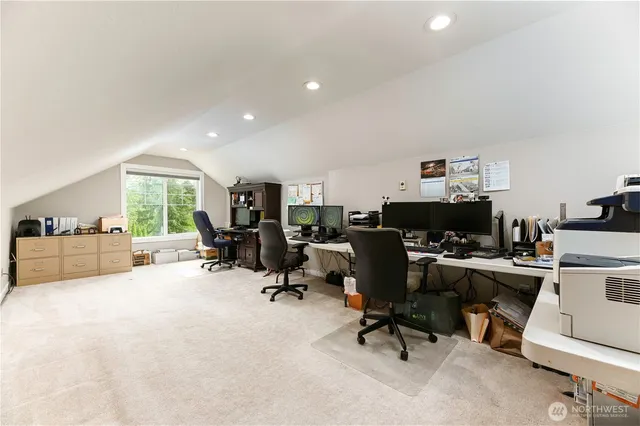a view of a workspace with furniture and a window