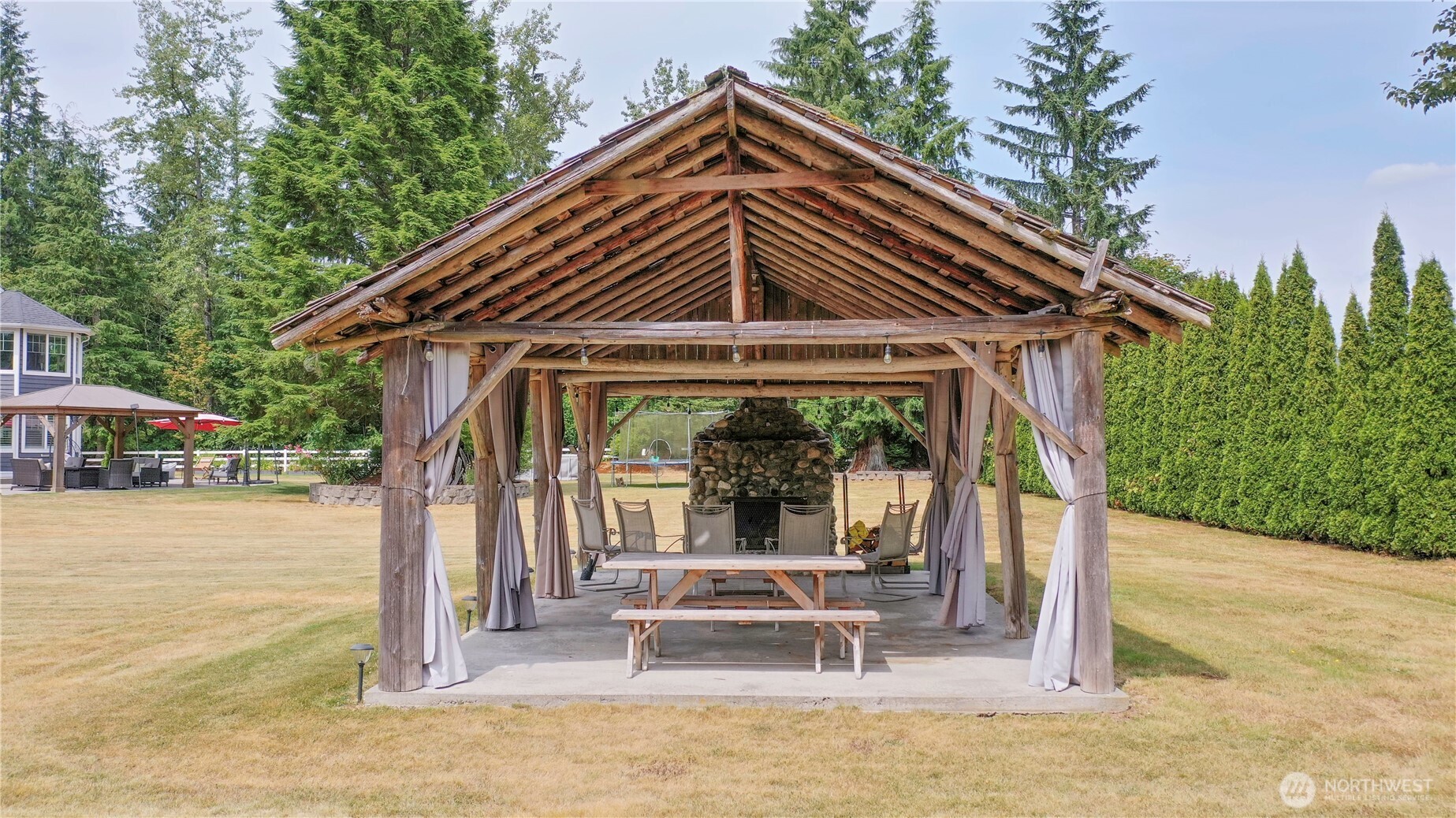 12523 Woods Lake Road Monroe, WA 98272 - Photo 33 of 40 a view of a house with backyard porch and sitting area