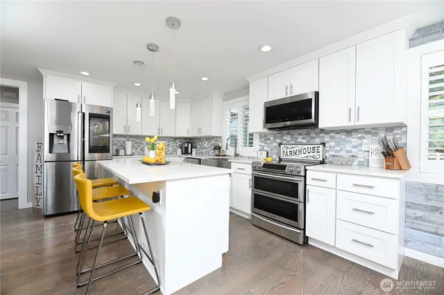 a kitchen with a stove a sink and a refrigerator