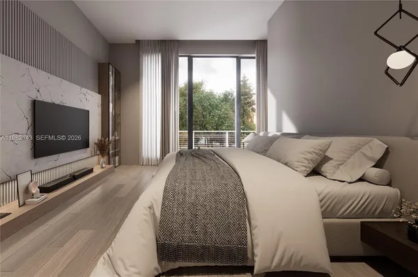 a spacious bedroom with a bed and a flat screen tv