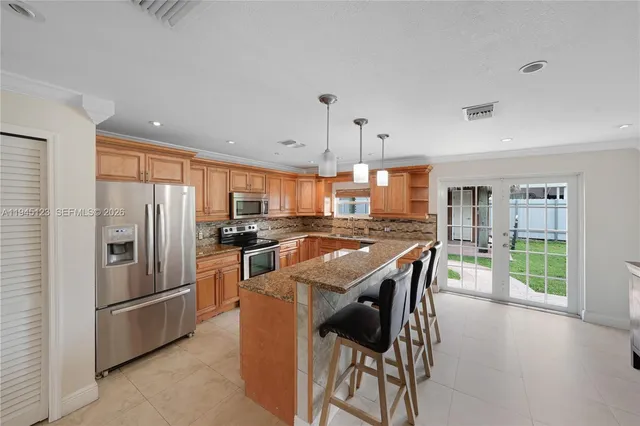 a kitchen with stainless steel appliances granite countertop a stove and cabinets