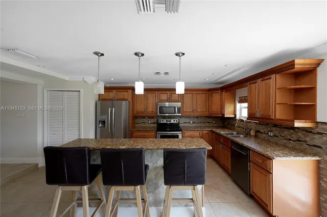 a kitchen with a stove and a refrigerator