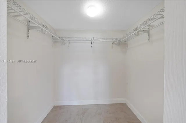 a view of backyard with a barn and a large tree
