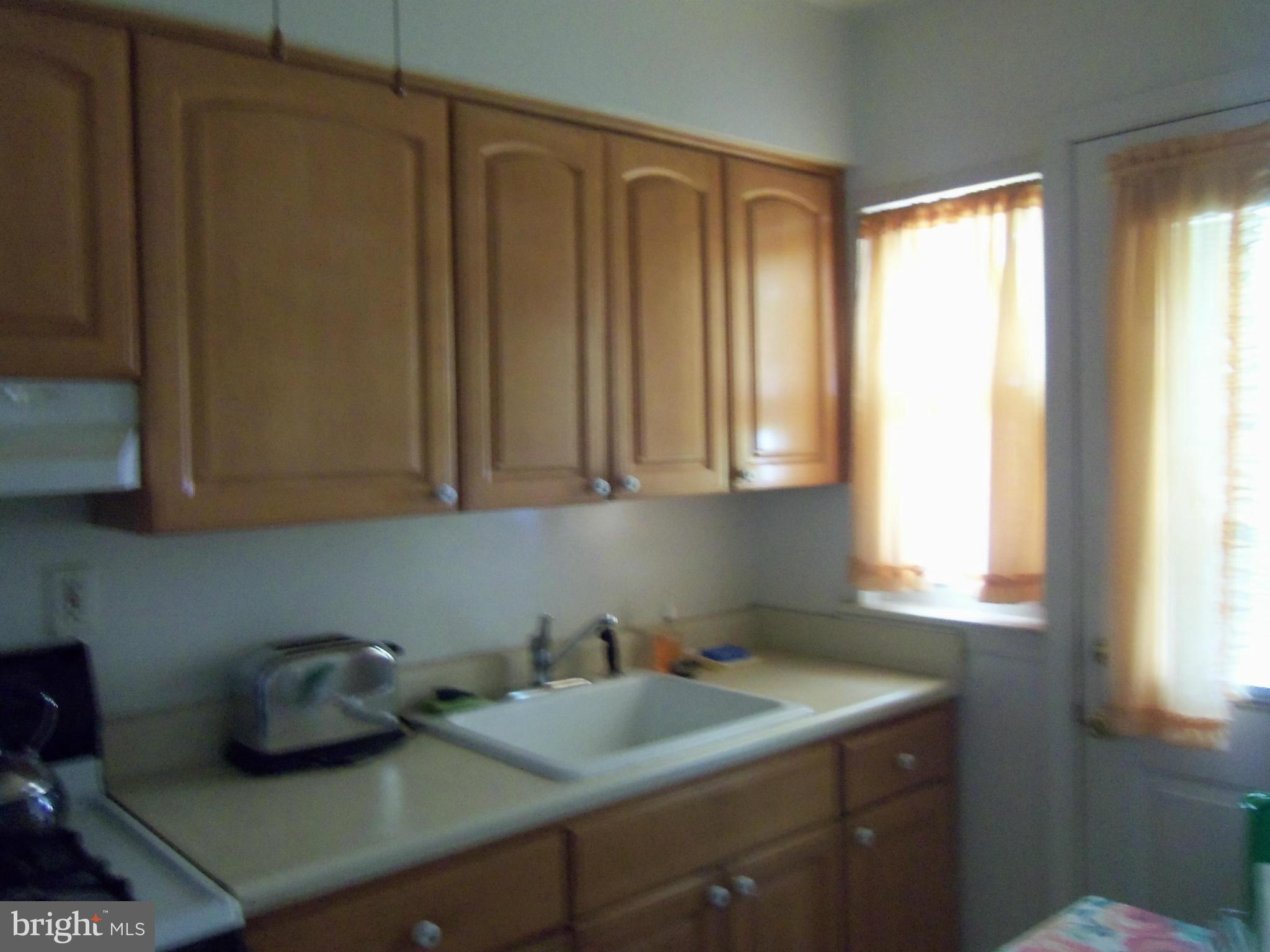 519 St Patrick Road Baltimore, MD 21206 - Photo 15 of 19 a kitchen with a sink cabinets and window