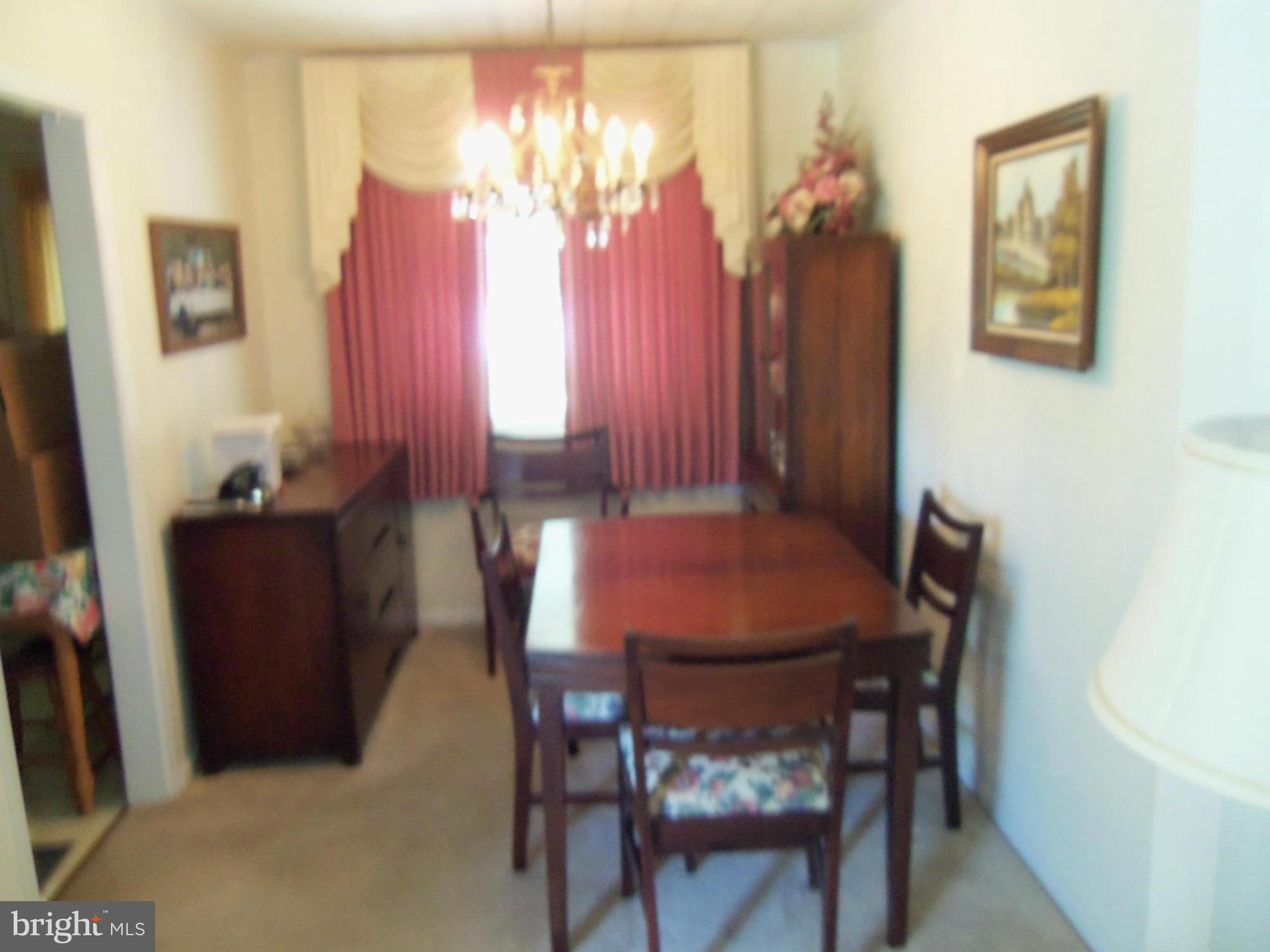 519 St Patrick Road Baltimore, MD 21206 - Photo 8 of 19 a view of a dining room with furniture and chandelier