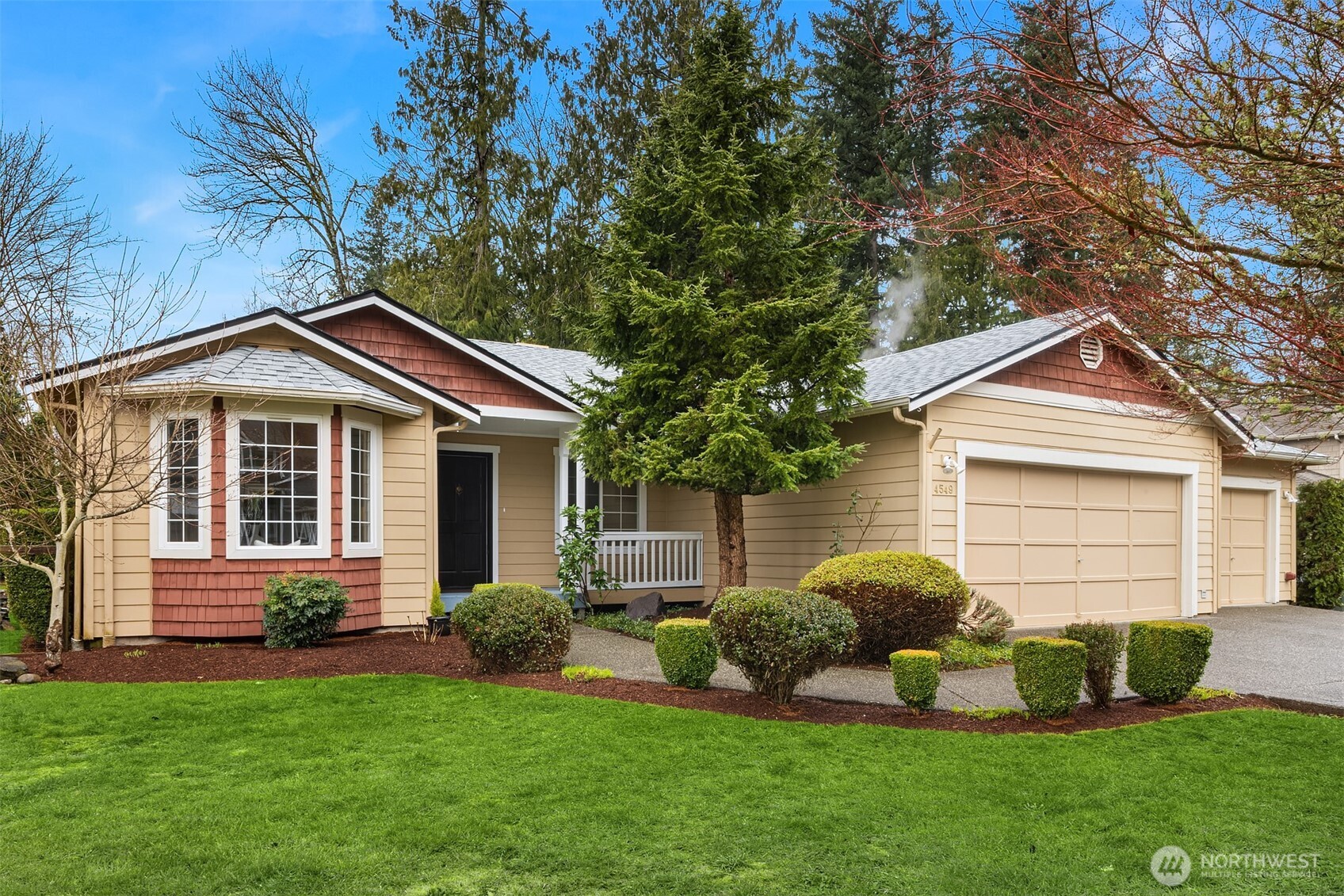 a front view of a house with a yard and garage