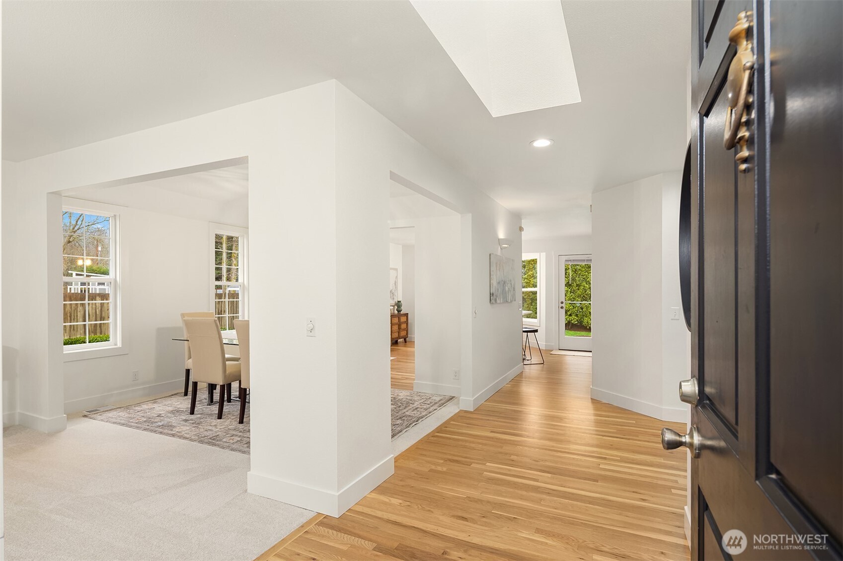 4549 329th Place Southeast Fall City, WA 98024 - Photo 2 of 35 a view of a hallway with wooden floor and a living room