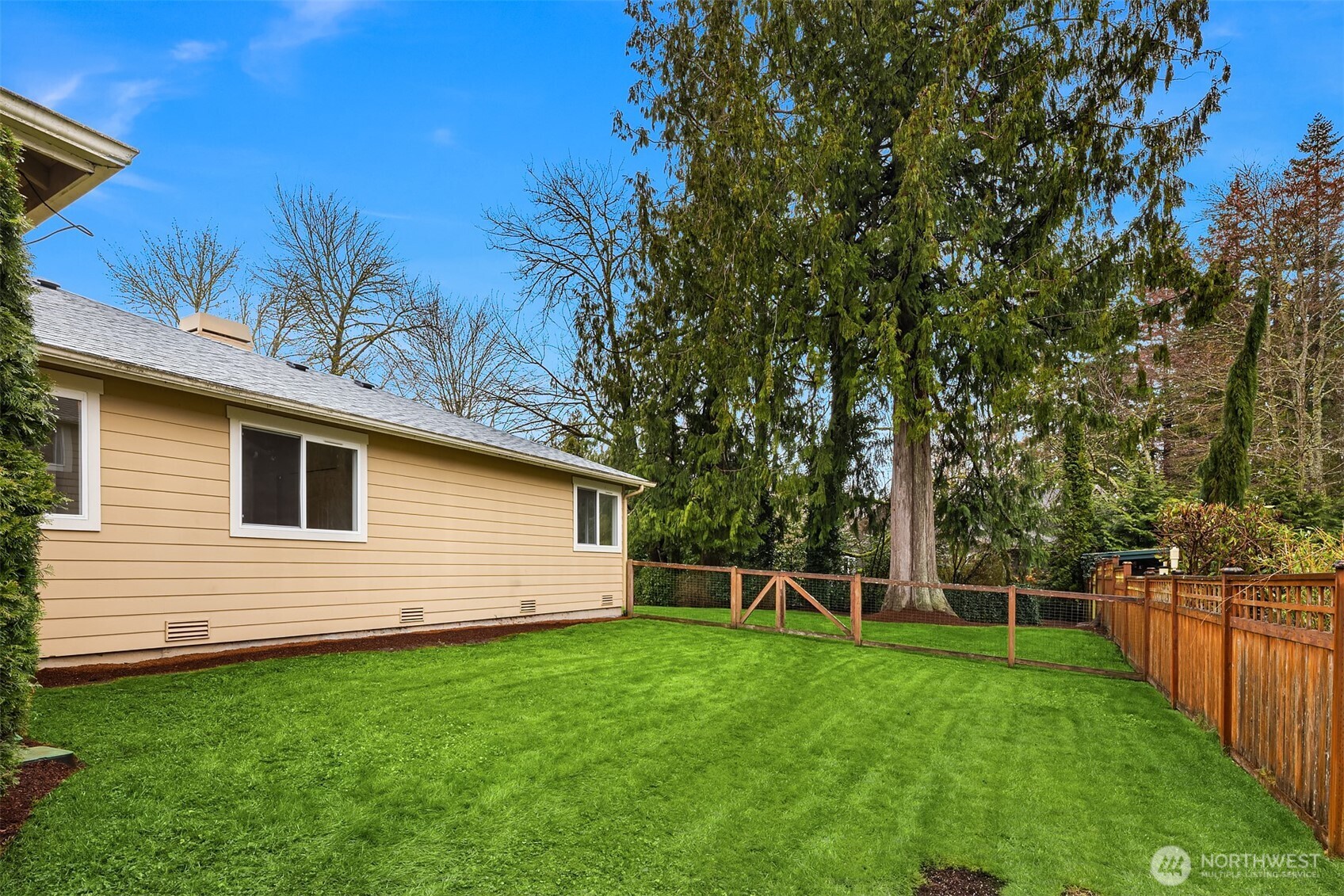 4549 329th Place Southeast Fall City, WA 98024 - Photo 31 of 35 a backyard of a house with plants and wooden fence