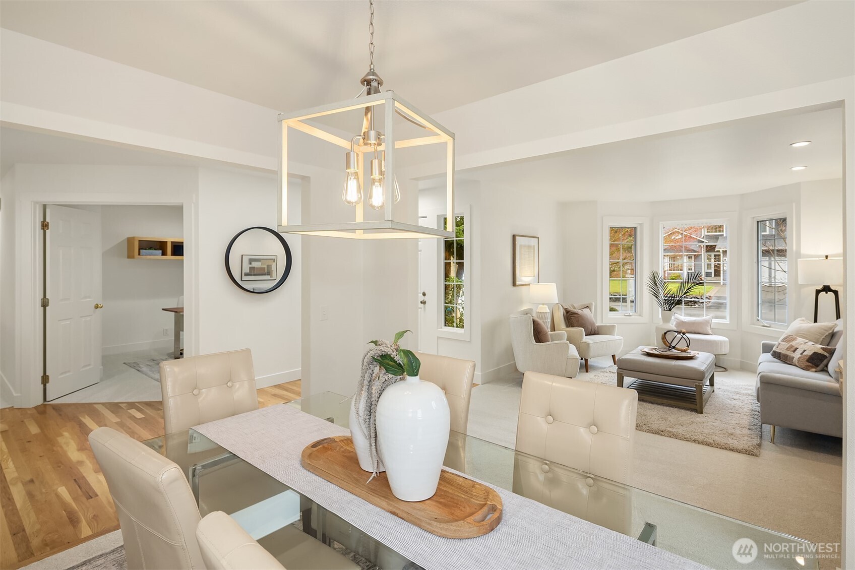 4549 329th Place Southeast Fall City, WA 98024 - Photo 7 of 35 a living room with couches a fireplace and a dining table with wooden floor