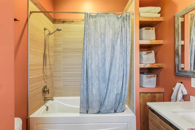 a bedroom with a bed and a potted plant