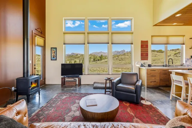 a bedroom with a large bed and painting on the wall