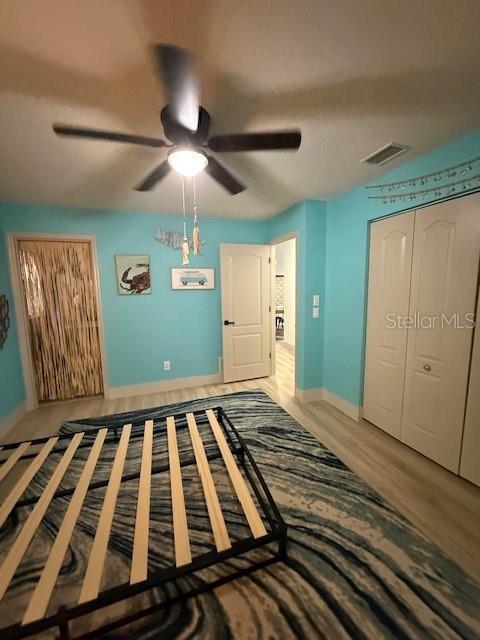 7 Federal Lane Palm Coast, FL 32137 - Photo 31 of 59 a bedroom with wooden floor closet and a ceiling fan