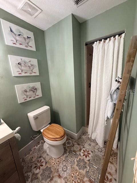 7 Federal Lane Palm Coast, FL 32137 - Photo 36 of 59 a bathroom with a toilet and a shower curtain